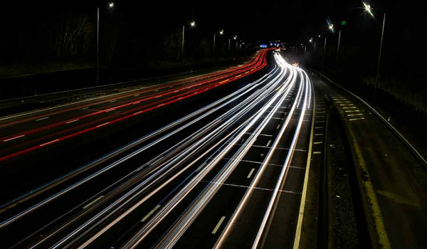 A time-elapsed photograph of cars on a highway at night