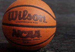 A close up photograph of a basketball. Text on the ball reads: Wilson. NCAA.