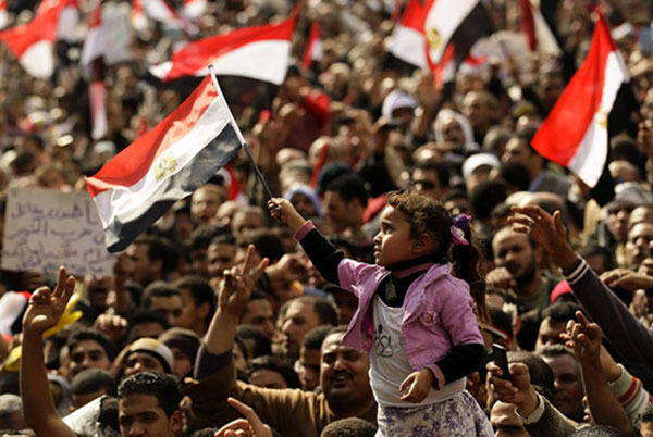 A girl waves the Egyptian national flag as thousands of demonstrators participate in antigovernment protests, February 8, 2011. Photo: Felipe Trueba / EPA / Thinking Images v.9