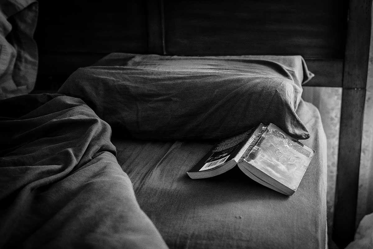 Open book on a bed. Photo by Steve Petrucelli