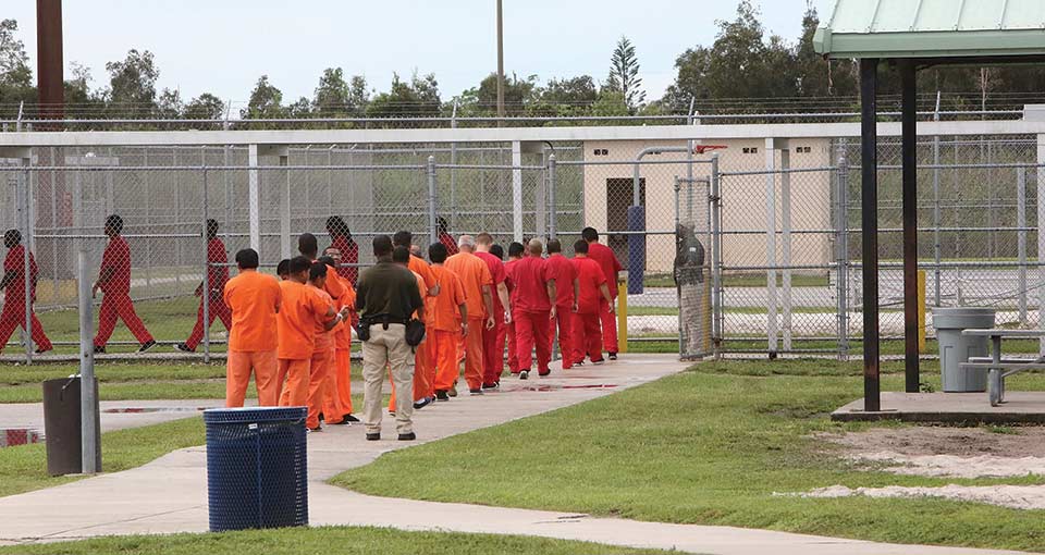 A group of detainees in orange jumpsuits at the Krome Detention Center. Photo: Getty Images