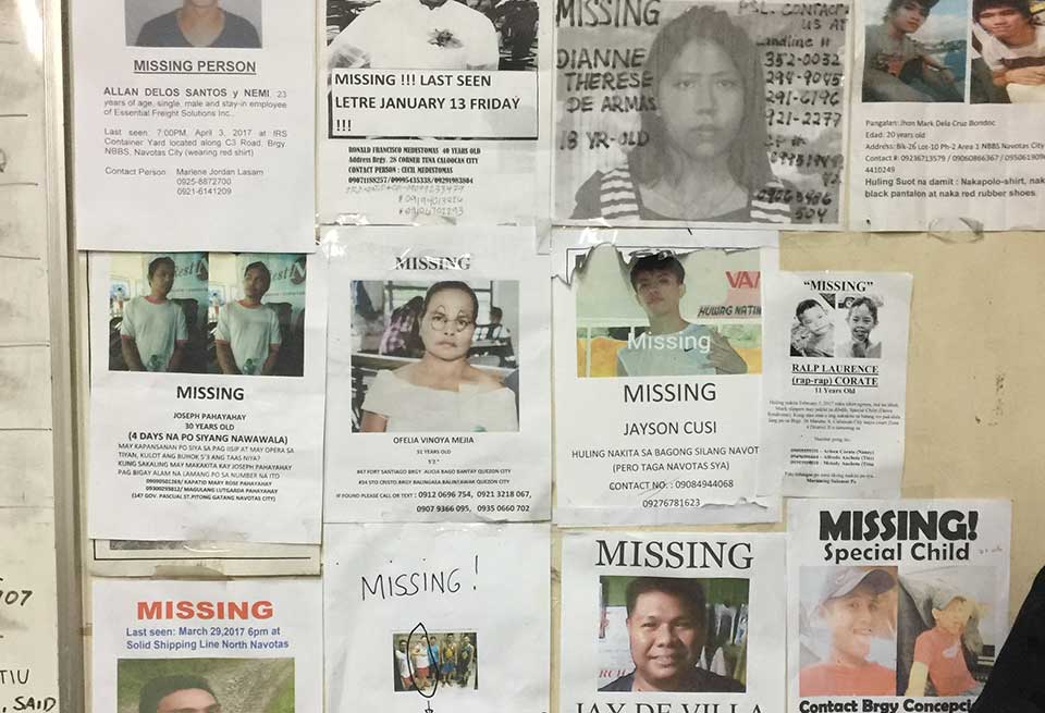A cropped photo of a bulletin board containing posters of the missing
