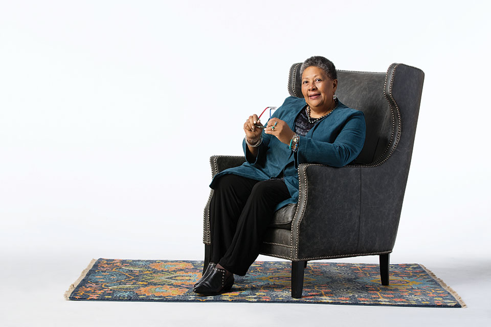 2017 NSK Laureate Marilyn Nelson sits in a chair in front of a stark white background