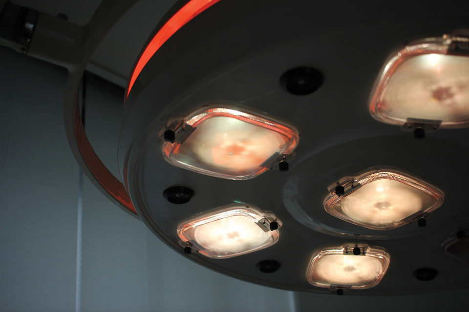 The lights in an operating room warming up for use