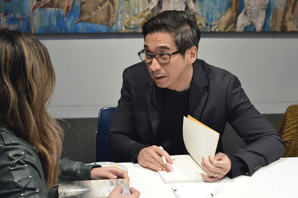 Author Joseph O. Legaspi speaks with a student during the 2019 Neustadt Lit fest