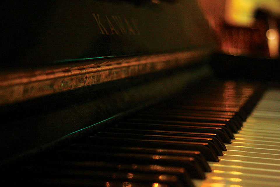 A close-up photograph looking down the keys on a piano