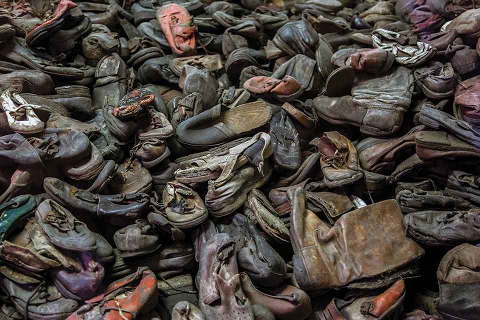 A photograph of a pile of discarded shoes