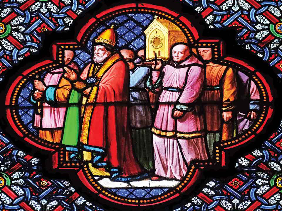 A stained glass image of robed figures in ecclesiastical garb