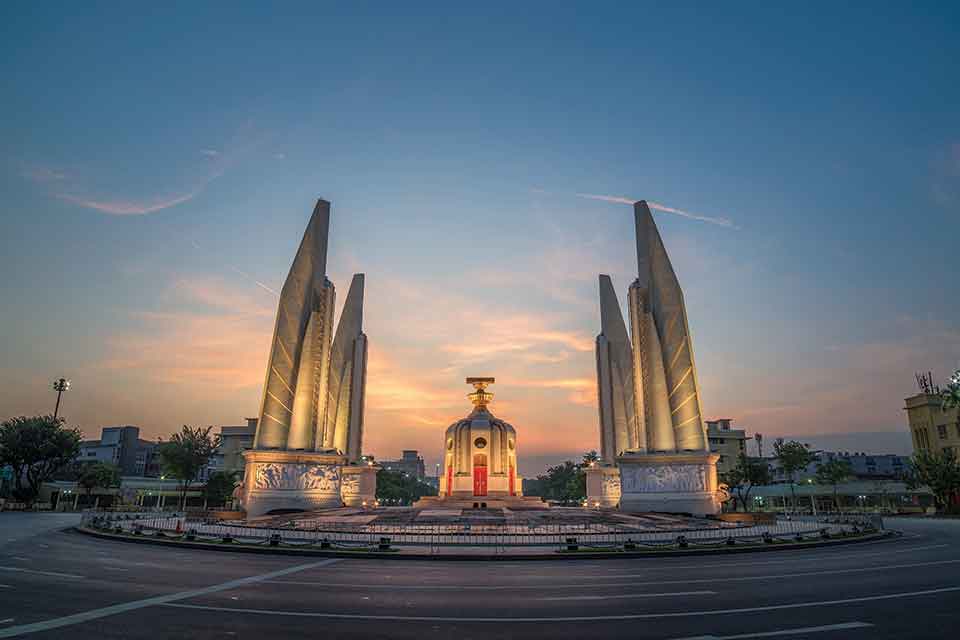A photograph of the Democracy Monument at with the sun just below the horizon