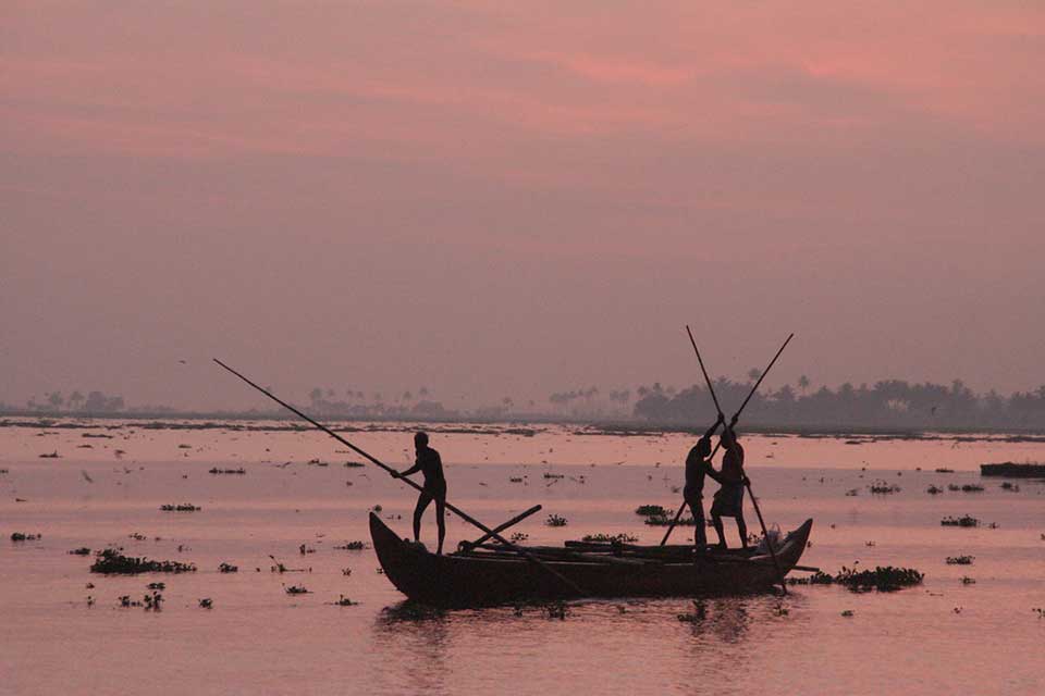Fishermen work before dawn on the coast off of Kerala