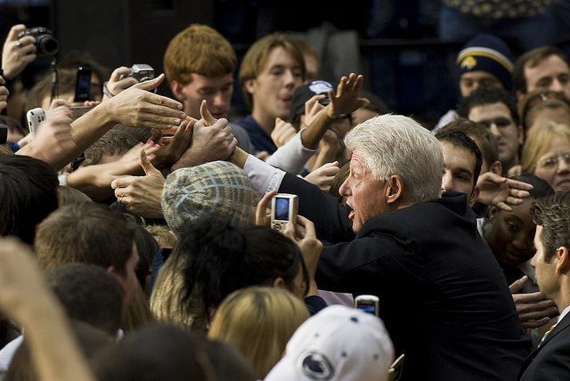 Bill Clinton shaking hands with students