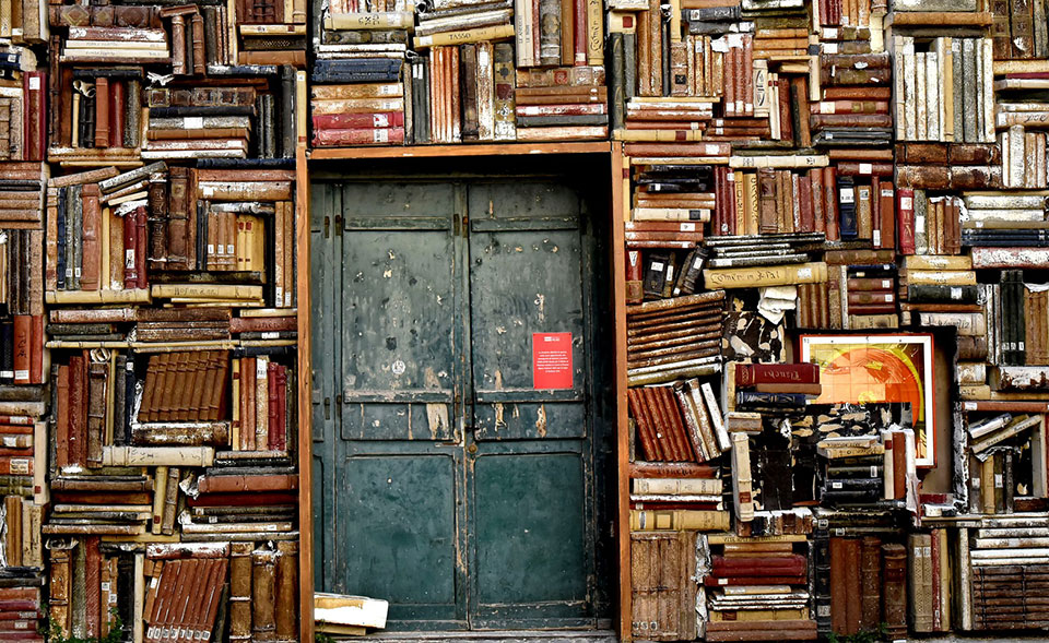 Books crowd the entrance to a building in Italy