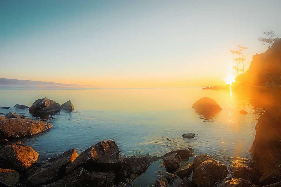A photograph of sunrise coming up over Lake Baikal