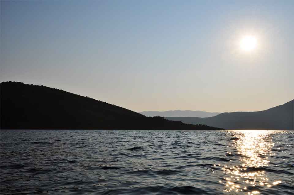 A photograph of a sunrise over the waters off of Ithaca in Greece