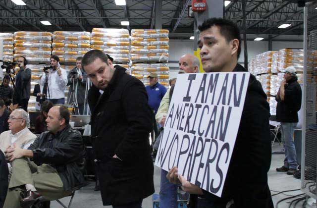 Jose Antonio Vargas holds a sign at a Mitt Romney presidential campaign rally in 2011 in a scene from his film “Documented.” Photo courtesy of Apo Anak Productions.