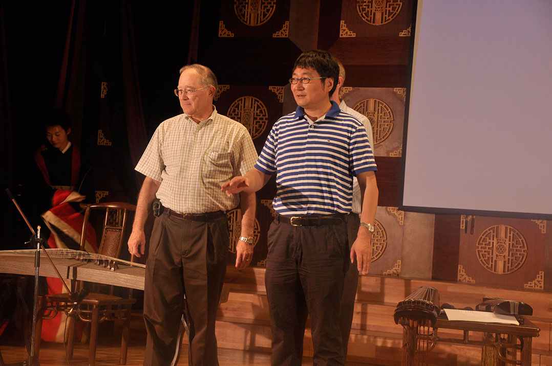 Producer Li Sen (at right), dean of the Art and Design program at Yunnan University, with Paul Bell, dean of the College of Arts & Sciences at OU, at the debut of Yingelishi at Yunnan University in 2010.