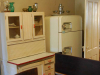 A photograph of a somewhat dated looking kitchen apartment