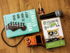 Copies of Jennifer Egan's A Visit from the Good Squad & (in translation) El tiempo es un canalla with a microphone, guitar pedal, and small guitar keychain