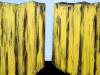 A painting of two tall cliffs, rendered in yellow