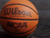 A close up photograph of a basketball. Text on the ball reads: Wilson. NCAA.