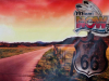 A color-altered photograph (emphasizing red tones) of a highway with a sign beside it in the foreground. The sign reads Route US 66. Another sign has been placed above it that read Miami Now, Native Oklahoma Weekend. Celebrating the past and future on Route 66.
