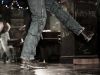 The legs of a dancer, clad in blue jeans and cowboy boots