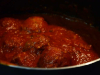 A photograph of meatballs in tomato sauc