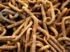 A photograph of a pile of rusted chains