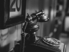 A black and white photo of a vintage phone in a study