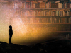 A collage of two image, one of a figure in silhouette staring up at the night sky overlaid on a crowded bookshelf