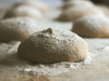 Lumps of worked dough, covered in flour