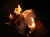 A photograph of paper burning up in a fire at night