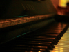 A close-up photograph looking down the keys on a piano