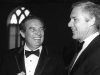 A black and white photo of Octavio Paz and William Banowsky dressed in suits and talking