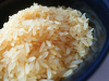 A bowl of rice, lightly colored by an application of soy sauce