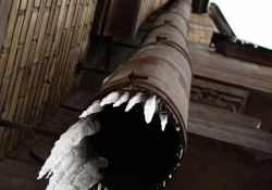 A photograph of a pipe with ice emerging from it, shot from below