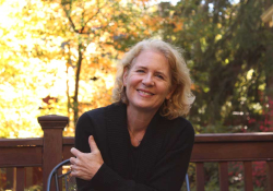 A photograph of author Suzanne Berne, who smiles at the viewer