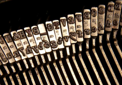A photograph of the row of arms on a manual typewriter 