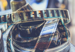 A coil of motion picture film is coming uncoiled