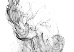Smoke drifting up into the air. black and white