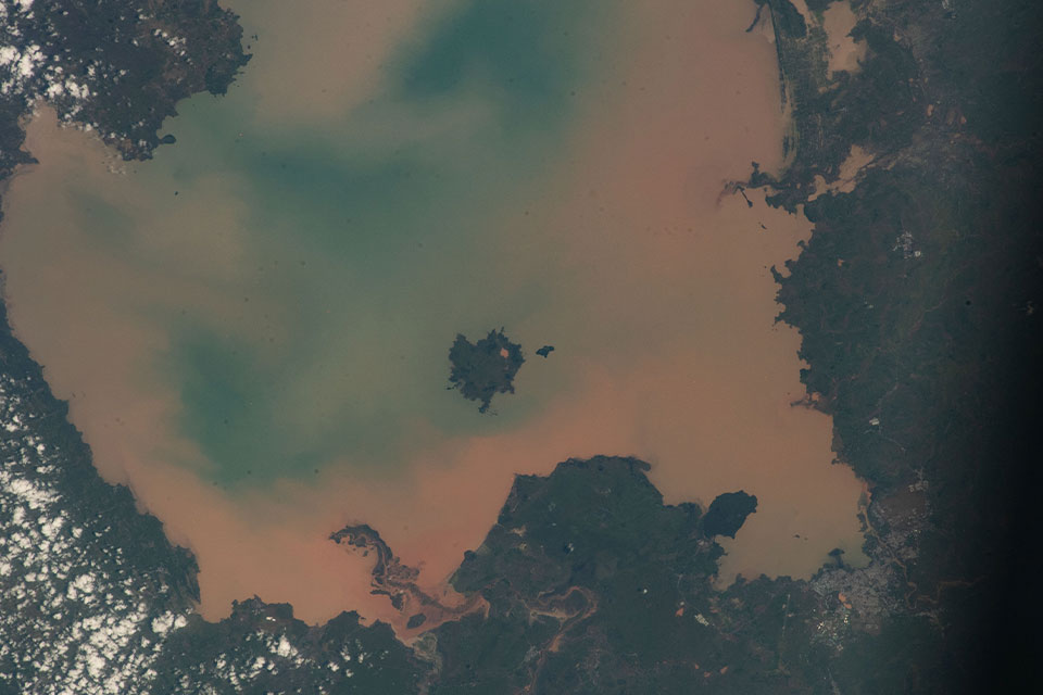 A satellite photograph of a muddy bay from space