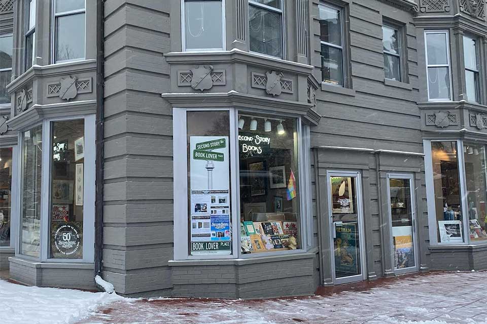 The exterior of a bookstore, which occupy the corner lot on a urban building