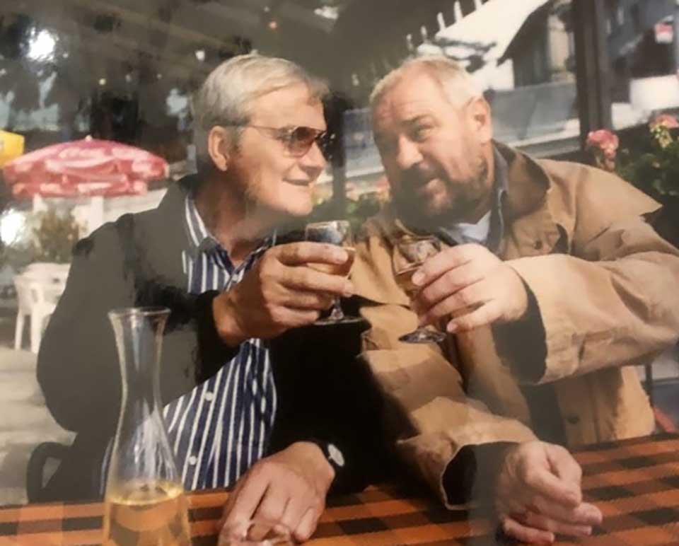Two older men sharing a beer