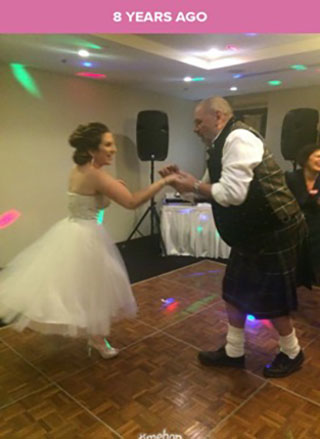 A young woman in bridal garb dancing with her father, who is wearing a kilt