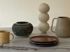 A photograph of five ceramic pieces staged on a table
