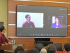 A photograph of Gene Luen Yang talking to Kelvin Yu via Zoom in front of a festival audience