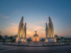 A photograph of the Democracy Monument at with the sun just below the horizon