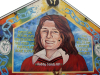 A mural with a painting of Bobby Sands. The text reads “Everyone. Republican or otherwise has their own particular role to play...our revenge will be the laughter of our children.”