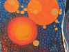An abstract painting of three large orange circles on a field of very small blue-grey ones