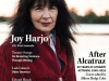 Joy Harjo, clad in a dark red coat against a snowy backdrop, looks directly at the viewer